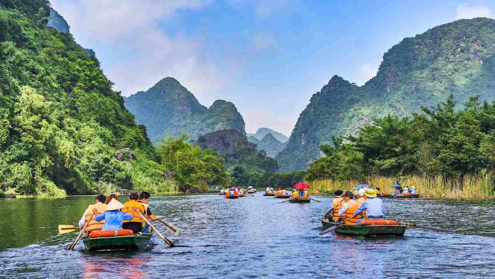 Glide through Tam Coc-Bich Dong’s scenic waterways for a peaceful boat ride among caves